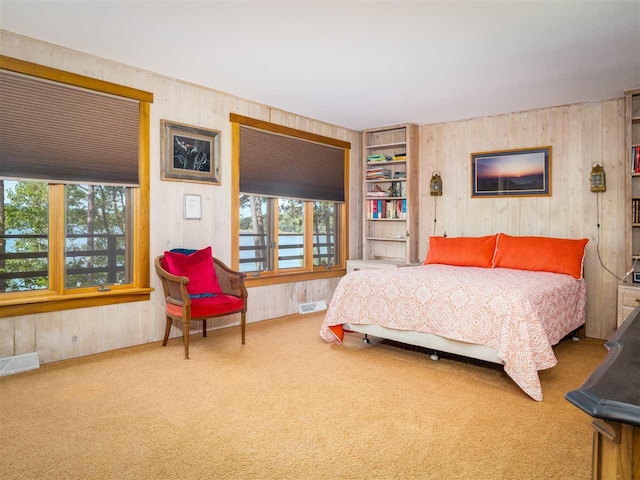 998 N Shr, Walloon Lake, MI 49796 - bedroom with wood walls and carpet floors