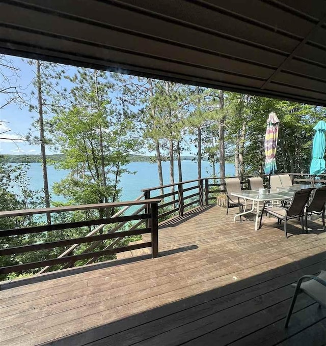 998 N Shr, Walloon Lake, MI 49796 - wooden deck with a water view and outdoor dining space