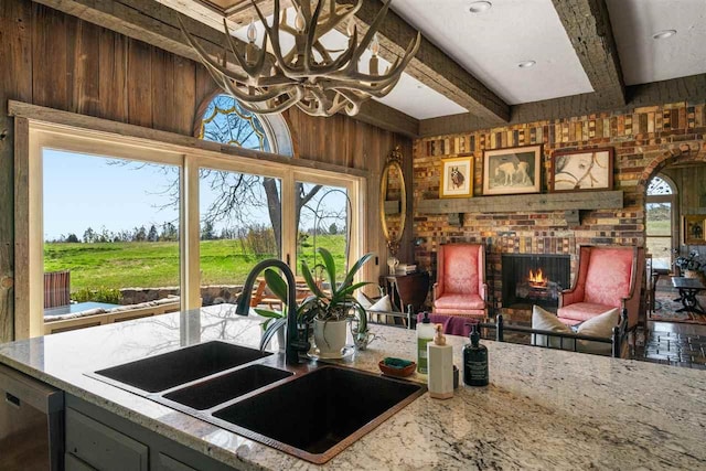 110 Birchwood Dr, Harbor Springs, MI 49740 - kitchen featuring a sink, plenty of natural light, a chandelier, wooden walls, and beam ceiling