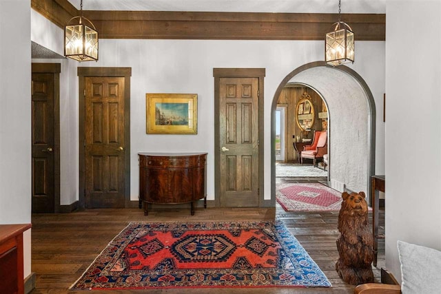 110 Birchwood Dr, Harbor Springs, MI 49740 - entrance foyer with a chandelier, arched walkways, and hardwood / wood-style flooring