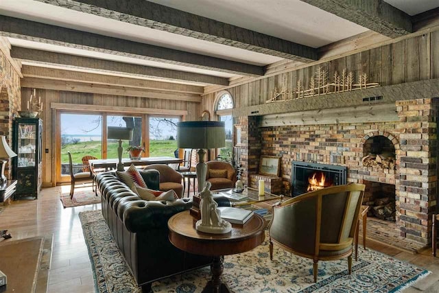 110 Birchwood Dr, Harbor Springs, MI 49740 - living room with a fireplace, wooden walls, beamed ceiling, and wood-type flooring