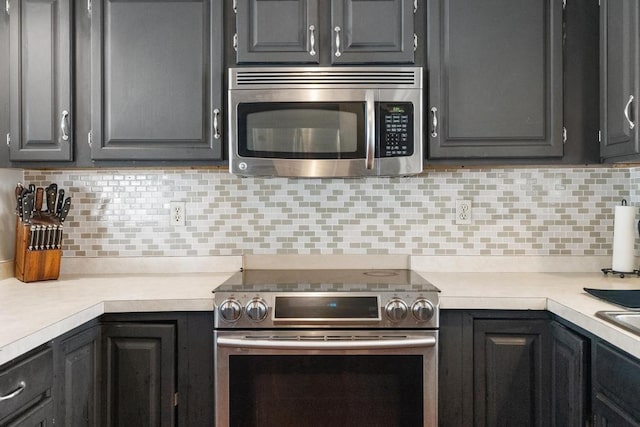 6141 S Old 31, Charlevoix, MI 49720 - kitchen with appliances with stainless steel finishes, light countertops, and backsplash