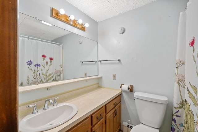 6141 S Old 31, Charlevoix, MI 49720 - bathroom featuring a drop ceiling, a baseboard heating unit, vanity, toilet, and a shower with curtain