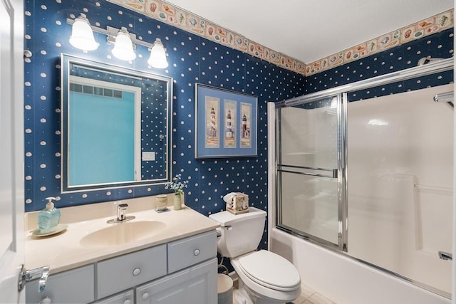12175 Cottage Ln Unit 2, Charlevoix, MI 49720 - full bathroom featuring wallpapered walls, vanity, combined bath / shower with glass door, toilet, and tile patterned flooring