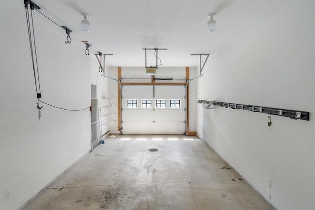 12175 Cottage Ln Unit 2, Charlevoix, MI 49720 - garage with a garage door opener and baseboards