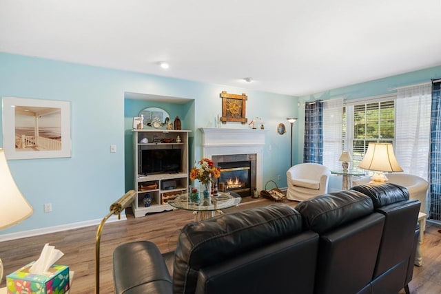 12175 Cottage Ln Unit 2, Charlevoix, MI 49720 - living room with a tile fireplace, wood finished floors, and baseboards