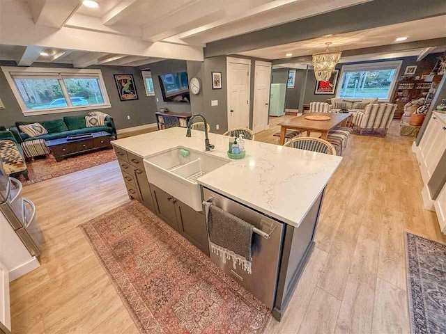 923 E Mitchell St, Petoskey, MI 49770 - kitchen featuring open floor plan, a chandelier, light wood-style floors, beam ceiling, and a kitchen island with sink