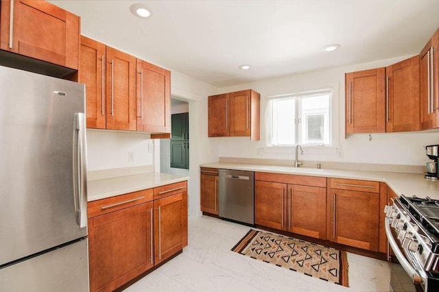 312 Grove St, Petoskey, MI 49770 - kitchen with appliances with stainless steel finishes, a sink, brown cabinets, light marble finish floors, and recessed lighting