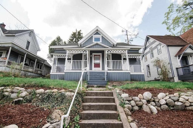 312 Grove St, Petoskey, MI 49770 - victorian house with a porch and board and batten siding