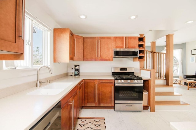 312 Grove St, Petoskey, MI 49770 - kitchen featuring stainless steel appliances, a sink, light countertops, recessed lighting, and brown cabinets