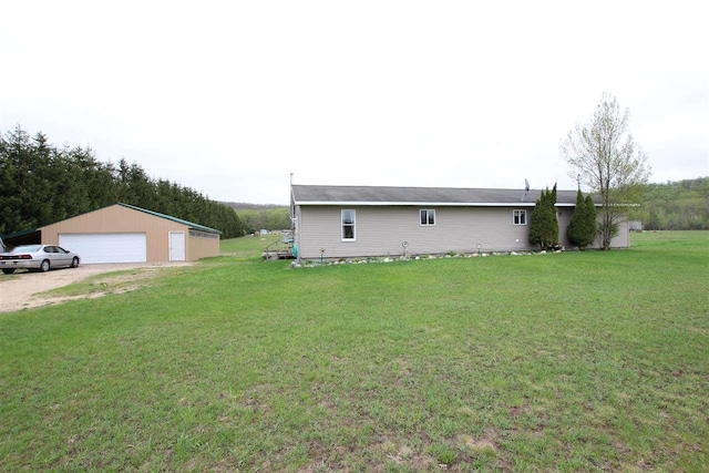 4155 Welsch Rd, Petoskey, MI 49770 - view of side of property with a garage, a lawn, and an outdoor structure