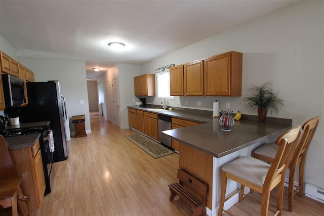 4155 Welsch Rd, Petoskey, MI 49770 - kitchen with black / electric stove, dishwasher, a sink, a peninsula, and light wood-style flooring
