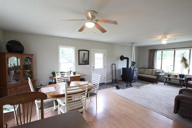4155 Welsch Rd, Petoskey, MI 49770 - dining area with a wood stove, a ceiling fan, and healthy amount of natural light