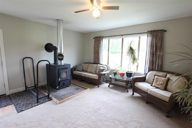 4155 Welsch Rd, Petoskey, MI 49770 - sitting room featuring a wood stove, carpet, and ceiling fan