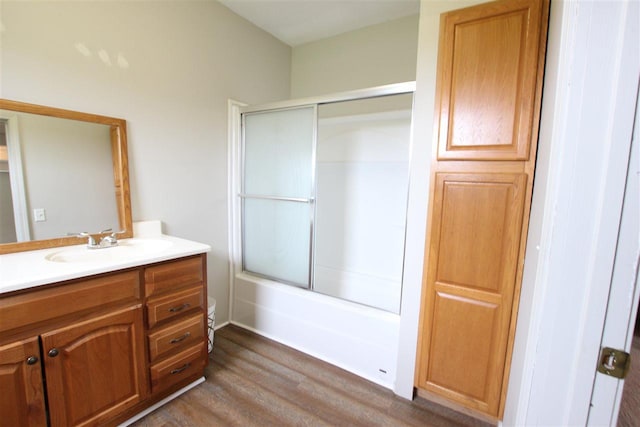 4155 Welsch Rd, Petoskey, MI 49770 - full bathroom featuring wood finished floors, vanity, and enclosed tub / shower combo