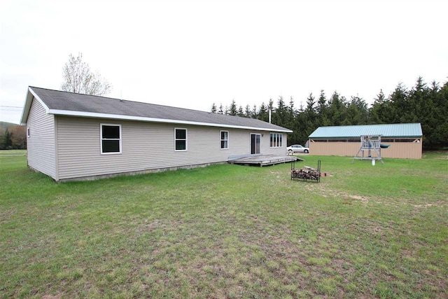4155 Welsch Rd, Petoskey, MI 49770 - back of property featuring a yard and an outdoor fire pit
