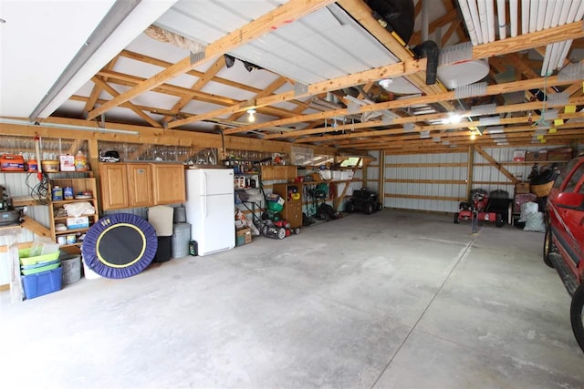 4155 Welsch Rd, Petoskey, MI 49770 - garage featuring freestanding refrigerator