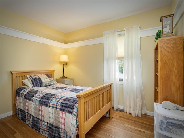 911 Regent Ct, Petoskey, MI 49770 - bedroom featuring hardwood / wood-style flooring and baseboards