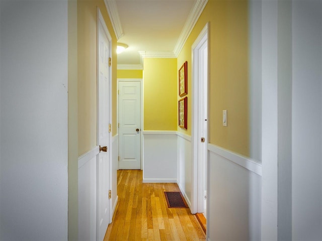 911 Regent Ct, Petoskey, MI 49770 - hallway featuring ornamental molding, light wood finished floors, and wainscoting