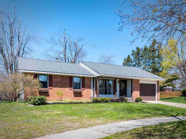 911 Regent Ct, Petoskey, MI 49770 - ranch-style house featuring brick siding, a garage, roof with shingles, and driveway