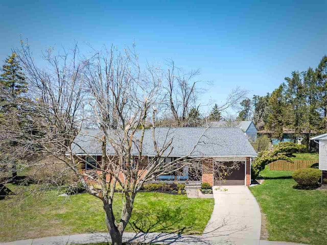 911 Regent Ct, Petoskey, MI 49770 - view of front of house with driveway and brick siding