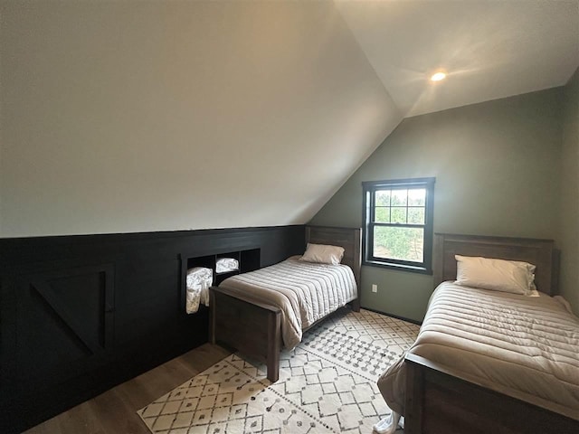 1645 Riley Rd, Kalkaska, MI 49646 - bedroom with vaulted ceiling and wood finished floors