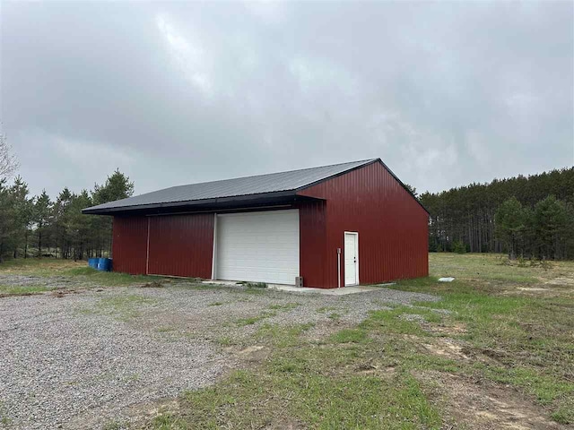 1645 Riley Rd, Kalkaska, MI 49646 - detached garage featuring a forest view