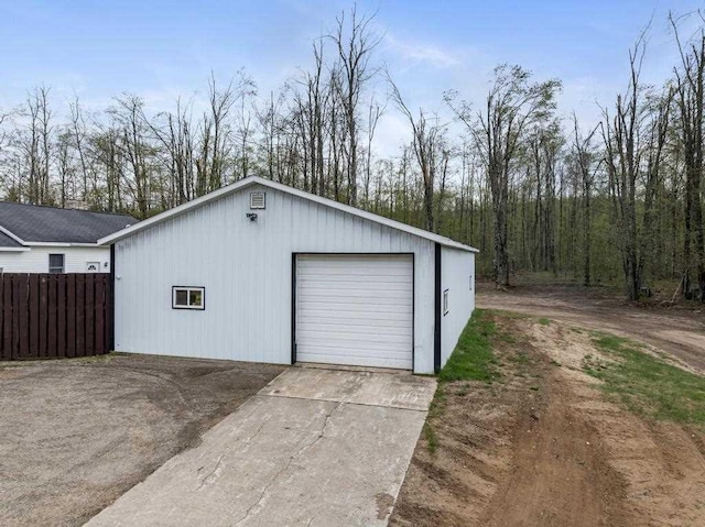 8900 Lewis Rd, Vanderbilt, MI 49795 - detached garage featuring fence and concrete driveway