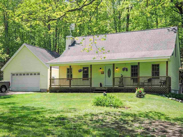 2729 Ranney Rd, East Jordan, MI 49727 - view of front of house featuring a porch, a chimney, a front lawn, and a garage