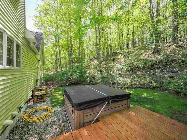 2729 Ranney Rd, East Jordan, MI 49727 - deck featuring a hot tub and fence