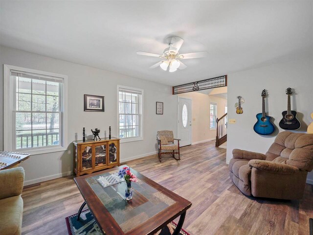 2729 Ranney Rd, East Jordan, MI 49727 - living room featuring plenty of natural light, light wood finished floors, ceiling fan, and baseboards