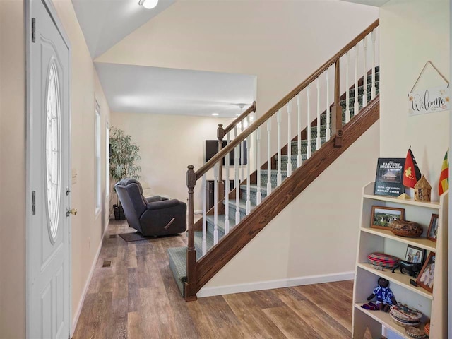 2729 Ranney Rd, East Jordan, MI 49727 - foyer featuring stairway, baseboards, and wood finished floors