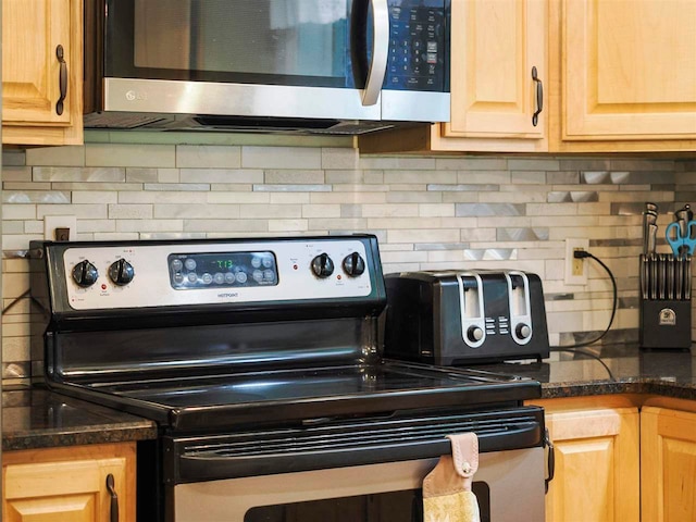 2729 Ranney Rd, East Jordan, MI 49727 - kitchen view of appliances with stainless steel finishes, decorative backsplash, and light brown cabinetry