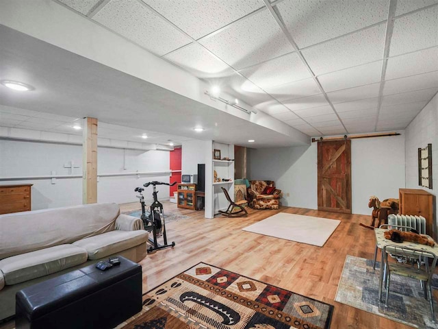 2729 Ranney Rd, East Jordan, MI 49727 - living room featuring a paneled ceiling and wood finished floors