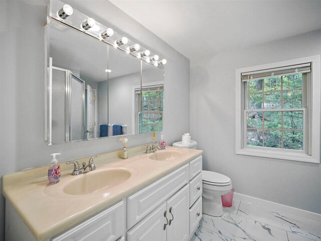2729 Ranney Rd, East Jordan, MI 49727 - bathroom with healthy amount of natural light, double vanity, baseboards, and a shower with shower door