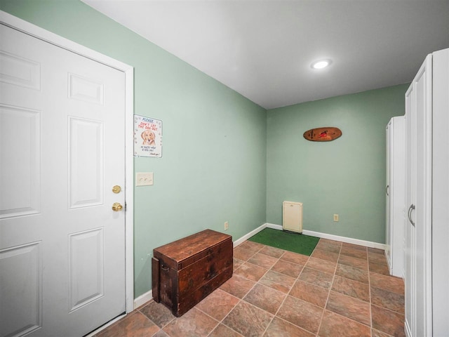 2729 Ranney Rd, East Jordan, MI 49727 - laundry room with baseboards, recessed lighting, and stone finish floors