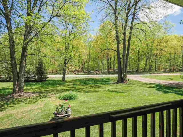 2729 Ranney Rd, East Jordan, MI 49727 - view of grassy yard featuring a wooded view