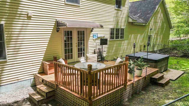 2729 Ranney Rd, East Jordan, MI 49727 - wooden terrace with french doors, a hot tub, outdoor dining area, and fence