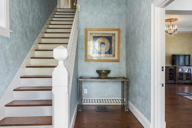 702 Michigan, Petoskey, MI 49770 - staircase featuring wood finished floors, a chandelier, and baseboards