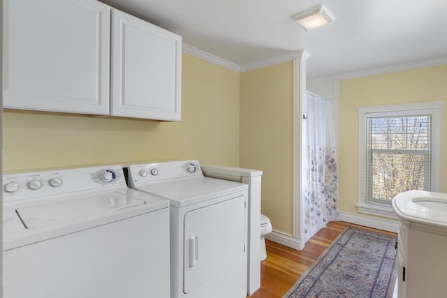 702 Michigan, Petoskey, MI 49770 - washroom with separate washer and dryer, crown molding, light wood finished floors, and baseboards