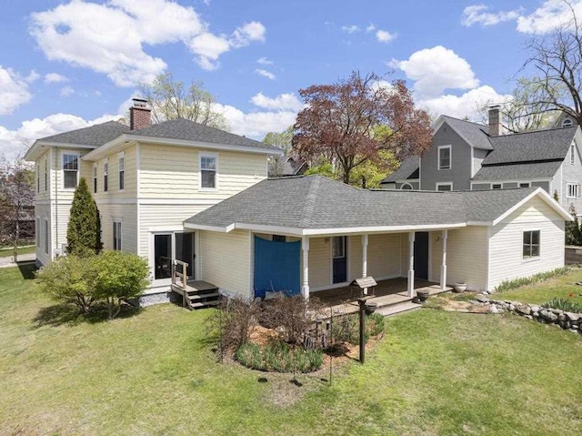702 Michigan, Petoskey, MI 49770 - view of front of property featuring a front yard, a chimney, a shingled roof, and covered porch