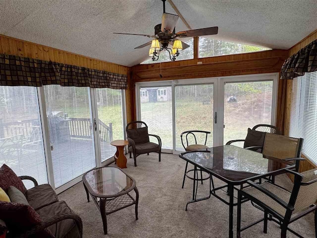 15500 Riverside Trl, Wolverine, MI 49799 - sunroom / solarium featuring lofted ceiling, a textured ceiling, a ceiling fan, wooden walls, and plenty of natural light