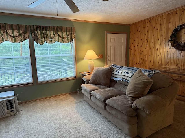 15500 Riverside Trl, Wolverine, MI 49799 - carpeted living room with ceiling fan, ornamental molding, plenty of natural light, wood walls, and a textured ceiling