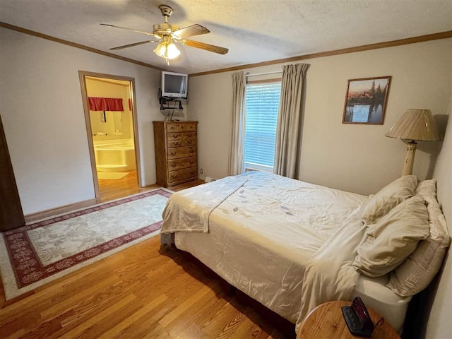 15500 Riverside Trl, Wolverine, MI 49799 - bedroom featuring wood finished floors, ornamental molding, a textured ceiling, ceiling fan, and ensuite bath