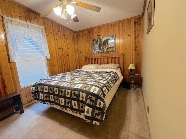 15500 Riverside Trl, Wolverine, MI 49799 - bedroom with carpet floors, multiple windows, wooden walls, ceiling fan, and crown molding