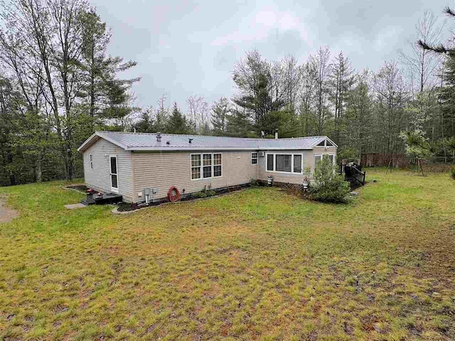 15500 Riverside Trl, Wolverine, MI 49799 - back of property featuring a lawn and metal roof