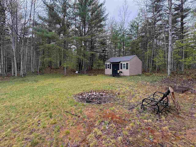 15500 Riverside Trl, Wolverine, MI 49799 - view of green lawn with an outdoor structure and a forest view