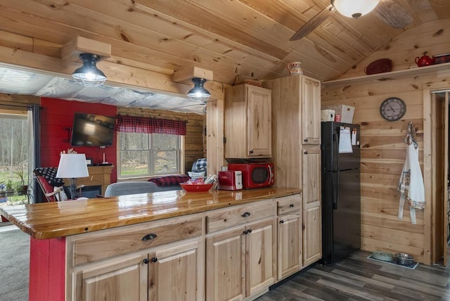 3622 Big Sky Trl, Gaylord, MI 49735 - kitchen with freestanding refrigerator, vaulted ceiling, dark wood-type flooring, wooden walls, and wooden ceiling