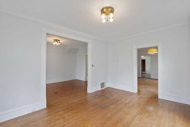 612 E Mitchell St, Petoskey, MI 49770 - unfurnished room featuring crown molding, baseboards, wood finished floors, and a chandelier