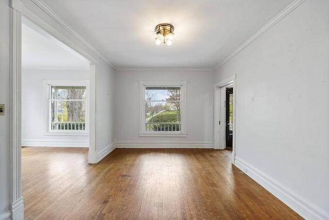 612 E Mitchell St, Petoskey, MI 49770 - unfurnished room with wood-type flooring, baseboards, and ornamental molding